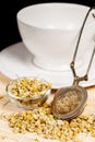 Dry chamomile with tea strainer and glass dish