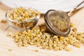 Dry chamomile with tea strainer and glass dish Royalty Free Stock Photo