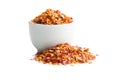 Dry chili pepper flakes in bowl. Crushed red peppers isolated on white background