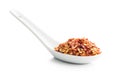 Dry chili pepper flakes in ceramic spoon. Crushed red peppers isolated on white background Royalty Free Stock Photo