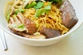 Dry Chinese egg noodles topping duck meat and bean sprout on bowl and stainless chopsticks Royalty Free Stock Photo
