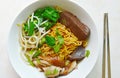 Dry Chinese egg noodles topping duck meat and bean sprout on bowl and stainless chopsticks Royalty Free Stock Photo