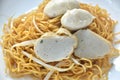 dry Chinese yellow noodles with bean sprout topping pork meatball and slice fish line on plate