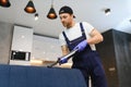 Dry cleaner's employee removing dirt from furniture in flat