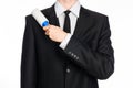 Dry cleaning and business theme: a man in a black suit holding a blue sticky brush for cleaning clothes and furniture from dust is Royalty Free Stock Photo