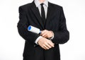 Dry cleaning and business theme: a man in a black suit holding a blue sticky brush for cleaning clothes and furniture from dust is Royalty Free Stock Photo