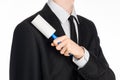 Dry cleaning and business theme: a man in a black suit holding a blue sticky brush for cleaning clothes and furniture from dust is Royalty Free Stock Photo