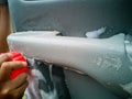 Dry cleaning the car interior with special foam. Car care concept. Car detailing. Cleaning driver seat using professional tools Royalty Free Stock Photo