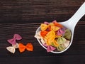 Dry colorful Italian pasta farfalle or bows in spoon Royalty Free Stock Photo