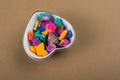 Dry colorful play dough in heart shaped bowl Royalty Free Stock Photo