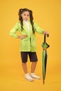 Dry and comfortable in rainy weather. small girl in raincoat with umbrella. schoolgirl waterproof raincoat. in good mood Royalty Free Stock Photo