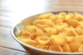 Dry conchiglie pasta shells in a stainless steel bowl Royalty Free Stock Photo