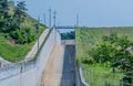 Dry concrete spillway on rural hillside Royalty Free Stock Photo