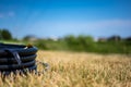 Coil of 1 inch irrigation tubing ready for new installation on top of brown and damaged dry grass. Royalty Free Stock Photo