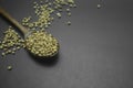 Dry coriander seeds in wooden spoon on black background Royalty Free Stock Photo