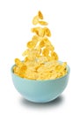 Dry corn flakes isolate in a blue ceramic plate, part of the corn flakes is flying in the air. traditional cornflakes breakfast Royalty Free Stock Photo