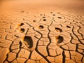dry cracked desert with footprints on sandy ground Royalty Free Stock Photo