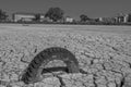 dry and cracked floor of the dry river of the big boiler in the city of Barreiro with buried old car tire