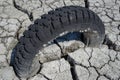 dry and cracked floor of the dry river of the big boiler in the city of Barreiro with buried old car tire