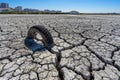 dry and cracked floor of the dry river of the big boiler in the city of Barreiro with buried old car tire