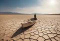 Dry cracked land without crops to horizon with boat and man in it. Dead soil and agricultural problems. Copy space Royalty Free Stock Photo