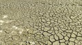 Dry cracked soil during drought on gray soil. Royalty Free Stock Photo