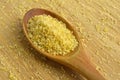 Cracked wheat daliya grains in wooden spoon, on bamboo cutting board Royalty Free Stock Photo