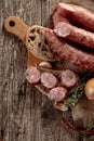 Dry-cured sausage with bread and spices on a old wooden table Royalty Free Stock Photo