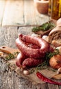 Dry-cured sausage with bread and spices on a old wooden table Royalty Free Stock Photo