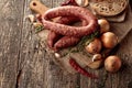 Dry-cured sausage with bread and spices on a old wooden table Royalty Free Stock Photo