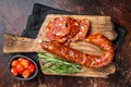 Dry cured Spanish Chorizo sausage, slices of meat with herbs and spices. Dark background. Top view Royalty Free Stock Photo