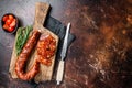 Dry cured Spanish Chorizo sausage, slices of meat with herbs and spices. Dark background. Top view. Copy space Royalty Free Stock Photo