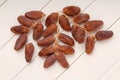 Dry dates are on branches, dried fruits are on white table