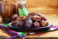 Dry dates on oriental ceramic plate with empty space