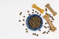 Dry dog pet food on white wooden background top view Royalty Free Stock Photo