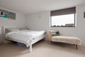 Furnished modern bedroom with double bed and chair