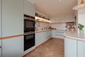 Modern kitchen with built in oven with white work top