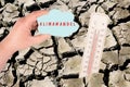 Dry earth with a thermometer, global warming concept, climate change is standing in german language on the cloud, environmental Royalty Free Stock Photo