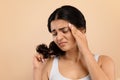 Dry Ends. Stressed young indian woman looking at her damaged hair Royalty Free Stock Photo