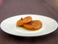 Dry fig dessert with sweet syrup as Turkish traditional sweet. Turkish name Incir Receli. Side view on white plate on