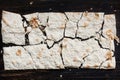 Dry flat bread broken in pieces and divided, with crumbs Royalty Free Stock Photo