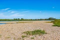 Dry floodplain on bank of Maas river with little water