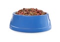 Dry food in blue pet bowl isolated on white Royalty Free Stock Photo