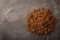 Dry food for cats on a cement background.