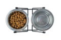 Dry food and water for cat or dog in metal bowls isolated on a white background. Top view Royalty Free Stock Photo