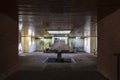 Dry fountain in the middle of backyard with wooden roof and skylight. Planters next to rustic steps Royalty Free Stock Photo