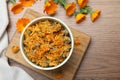 Dry and fresh calendula flowers on wooden table, flat lay. Space for text Royalty Free Stock Photo