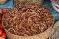 Dry fried grasshopper or locust insect on display at street food market in Madagascar