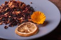 dry fruit tea flower and lemon on plate. Nice red wood table. Concept of health food Royalty Free Stock Photo