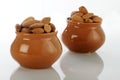 Dry Fruits Almonds in Ceramic Pot on white